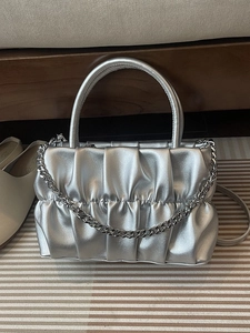 Silver pleated accordion handbag with cylindrical handle and chunky chain strap decor