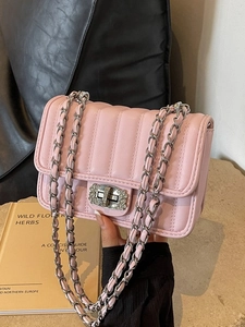 Pink quilted crossbody bag with silver rhinestone lock and chain strap hand-held