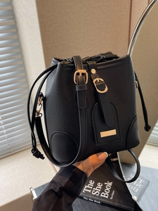 Retro black litchi pattern leather bucket bag with gold hardware and drawstring