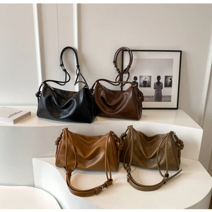 Boston shoulder bags in four colors with glossy oil-wax leather on geometric stands