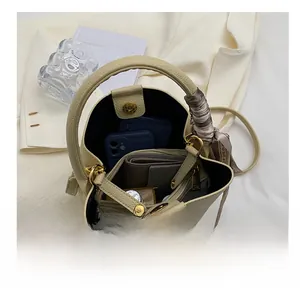Detailed interior of beige bucket bag with scarf handle showing spacious capacity