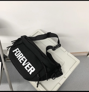 Detail of black canvas fanny pack featuring white FOREVER lettering and nylon strap