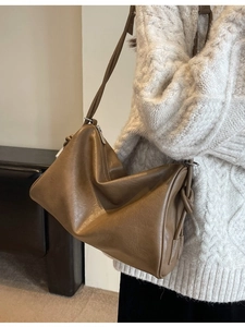 Brown faux leather Boston bag with side knot detail and adjustable crossbody strap