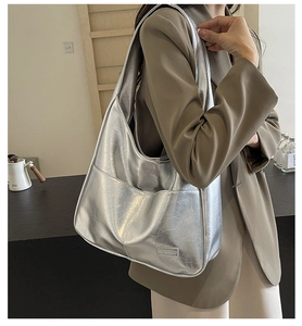 Detail of silver metallic hobo bag featuring crinkled texture and Fashion logo label