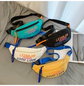 Flat lay of colorful nylon waist bags in blue, black, white, and yellow with bold lettering