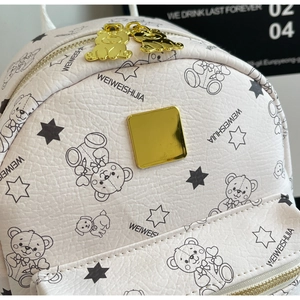 Detail des cremefarbenen Rucksacks mit Lychee-Lederstruktur und goldenen Bären-Zippern