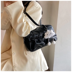 Close-up of black retro bowling bag with bow pleats and cute white cloud pendant