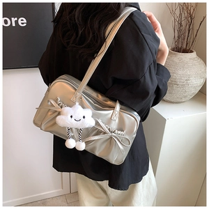 Detail of silver metallic bowling bag with bow drawstring and plush cloud pendant