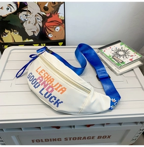 Detail of white nylon waist bag featuring pixel-style graphics and blue adjustable strap