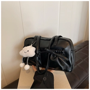Close-up of black retro bowling bag with bow pocket and cute cloud charm detail