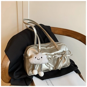 Detail of silver metallic bowling bag with bow decoration and cloud plush charm