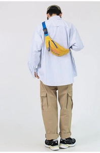 Back view of model wearing a bright yellow crossbody bag with contrast blue straps