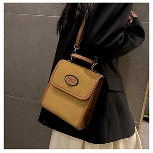 Detail of vintage suede shoulder bag with NICE FASHION logo and contrast trim