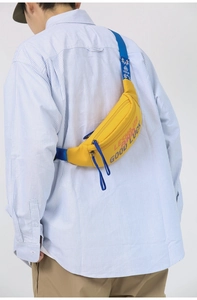 Detail of yellow nylon waist bag showing Good Luck print and textured blue strap