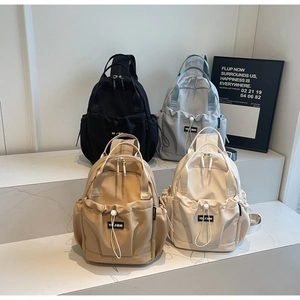 Detailed arrangement of nylon backpacks in black, blue, khaki and beige colors