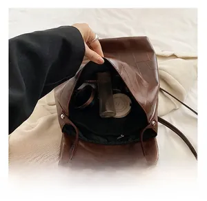 Macro view of large capacity interior with zipper pocket in vintage brown leather bag