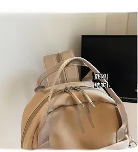 Detail of sturdy nylon backpack top handle with reinforced stitching and double zippers
