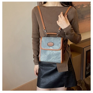Detail of retro faux suede backpack with contrast leather trim and Nice Fashion logo