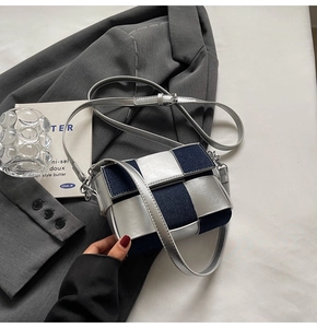 Close-up of silver and blue patchwork crossbody bag with textured metallic finish