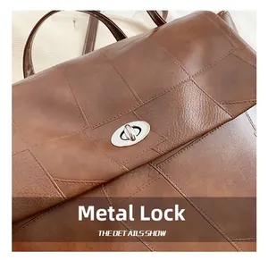 Detail of vintage brown leather backpack showing silver oval metal turn-lock and stitching