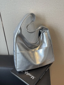 Metallic silver hobo tote bag with crinkled texture and spacious shoulder strap design