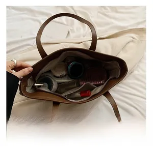 Interior view showing the large capacity and pockets of the brown leopard tote bag