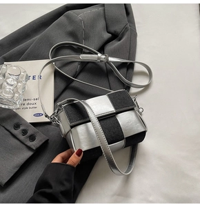 Detail view of woven checkered crossbody bag in silver metallic and black denim textures