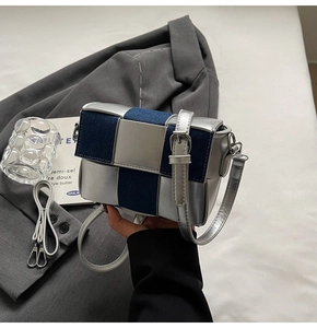 Close-up of contrast crossbody bag featuring silver metallic and blue denim weaving texture
