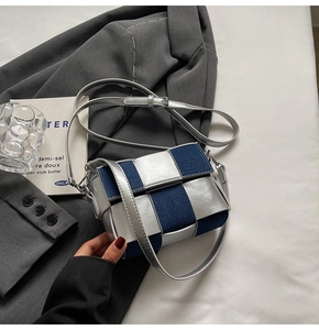 Detail of silver patent leather and blue denim woven small square crossbody bag