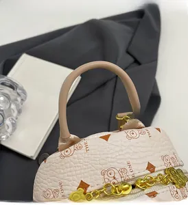 Detail of beige pebbled leather backpack with bear pattern and gold chain zipper puller