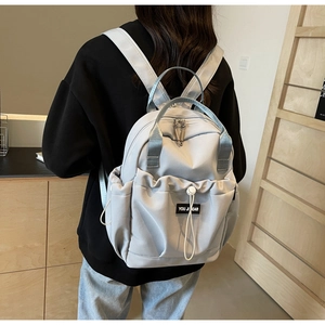 Close-up of lightweight nylon travel backpack with drawstring pocket and padded straps