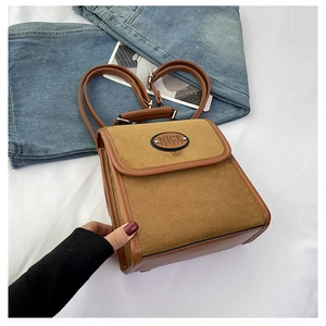 Detail of vintage suede backpack showing two-tone camel texture and top handle