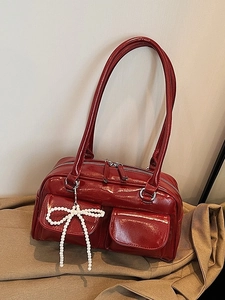 Glossy red Boston bag with double pockets and decorative pearl bow charm pendant