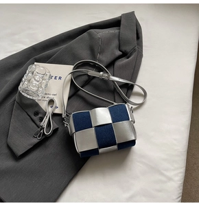Close-up of metallic silver and denim blue woven texture on this stylish crossbody bag