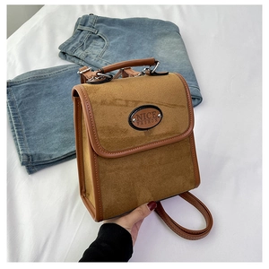 Close-up of vintage brown faux suede backpack with leather trim and NICE FASHION plate