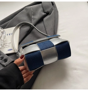 Detailed view of the large woven denim and silver metallic texture on this shoulder bag