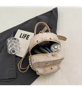 Top-down view of cream backpack interior showing large storage space for daily essentials