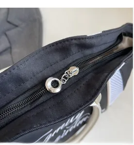 Detail of smooth silver ring zipper on large capacity black nylon tote bag
