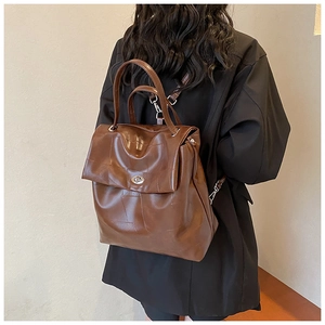 Close-up of brown PU leather backpack with silver twist lock and minimalist design