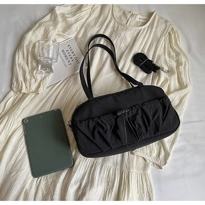 Detail of black ruched nylon shoulder bag with drawstring and adjustable strap