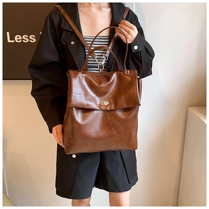 Brown vintage leather backpack with geometric texture and silver metal twist lock detail