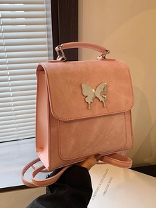 Sac à dos et bandoulière rose en similicuir avec décoration de papillon en métal chic