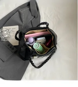 Interior view of large black tote bag showing spacious capacity for tablet and accessories