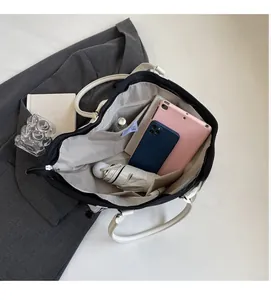 Interior view of large tote bag showing spacious compartments with tablet and phone