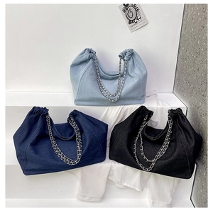 Detailed comparison of three denim tote bags in light blue, dark blue and black with chains
