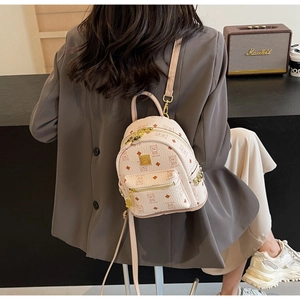 Detailed view of beige faux leather backpack featuring cartoon bears and the one pattern