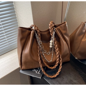 Brown leather tote bag featuring woven handles and silver chain with pearl charms