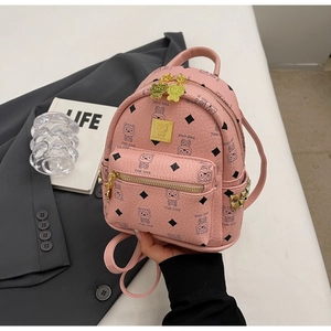 Pink mini backpack detail featuring cartoon bear print, pebble leather, and gold hardware