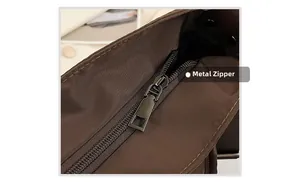 Close-up of durable metal zipper on a dark brown waterproof nylon tote bag
