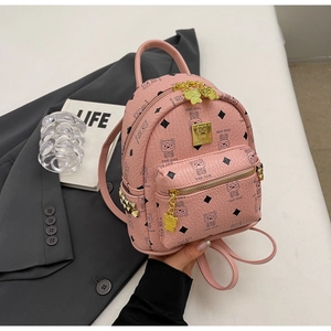 Detail of pink PU leather mini backpack with bear patterns and golden hardware